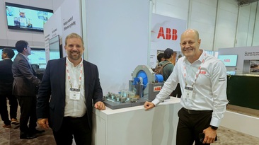 ABB's Francis Lacasse (left) and Wilson Monteiro next to a working model of a gearless mill drive, at MINExpo. Photo: Beth McLoughlin