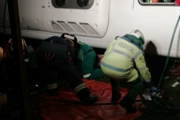 Passengers trapped under crashed bus
