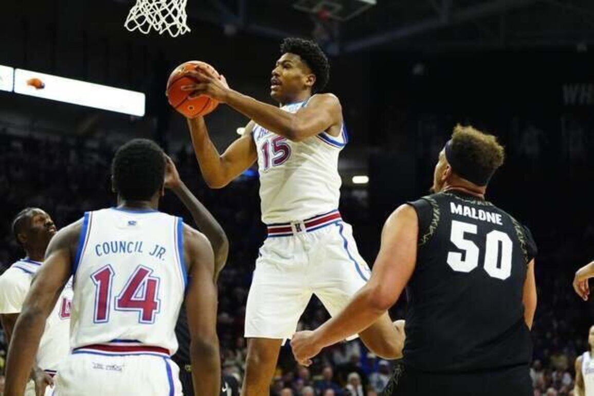 Without Bill Self, No. 19 Kansas hangs on to beat Colorado