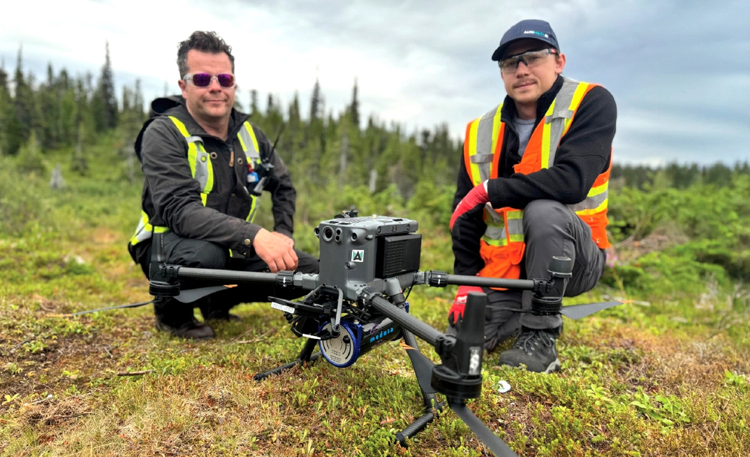 Altomaxx technicians prepare a DJI M350 RTK drone and gamma-ray spectrometer for a survey 