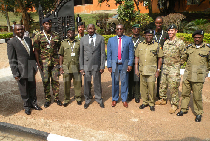  inister of tate for nternal ffairs ario biga poses for a group photo with security instructors during the opening of the oneweek training of the security enforcement on small fire arms 