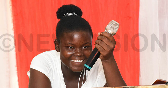 iana iramia from ulu gives a testimony of her childhood during the celebrations to mark 100 years of ave the hildren on hursday hoto by palanyi sentongo