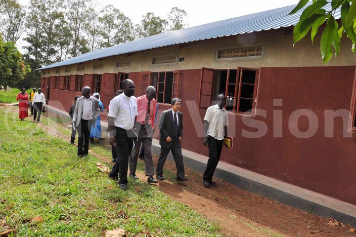 he mbassador of mbassy of apan azuaki ameda centre and members of the school management committee inspecting the girls dormitory constructed by the apanese overnment in ulu district 