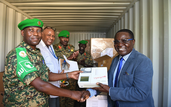  chief medical officer r oberts nebunne right and other senior officials hand over four containers of medical equipment in ogadishu  hoto
