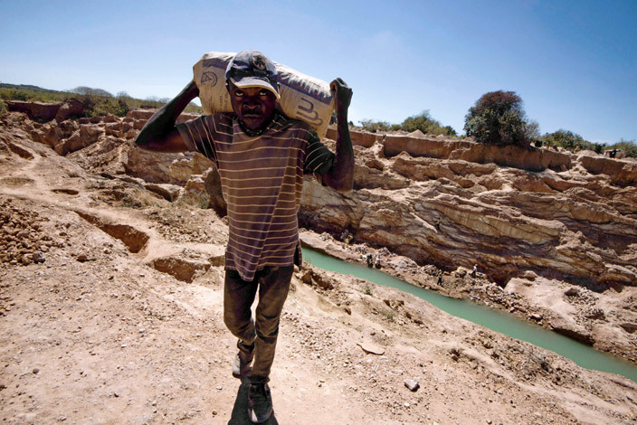  his file photo taken on ay 23 2016 shows a man carrying a bag of copper at a mine quarry and cobalt pit in ubumbashi    