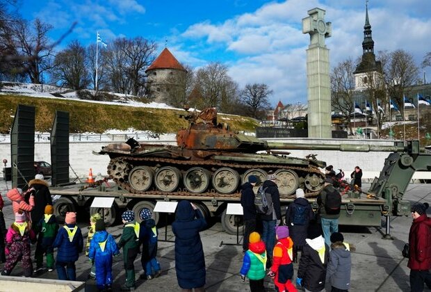 Russians Place Flowers at Burned-Out Tanks in Baltic Cities