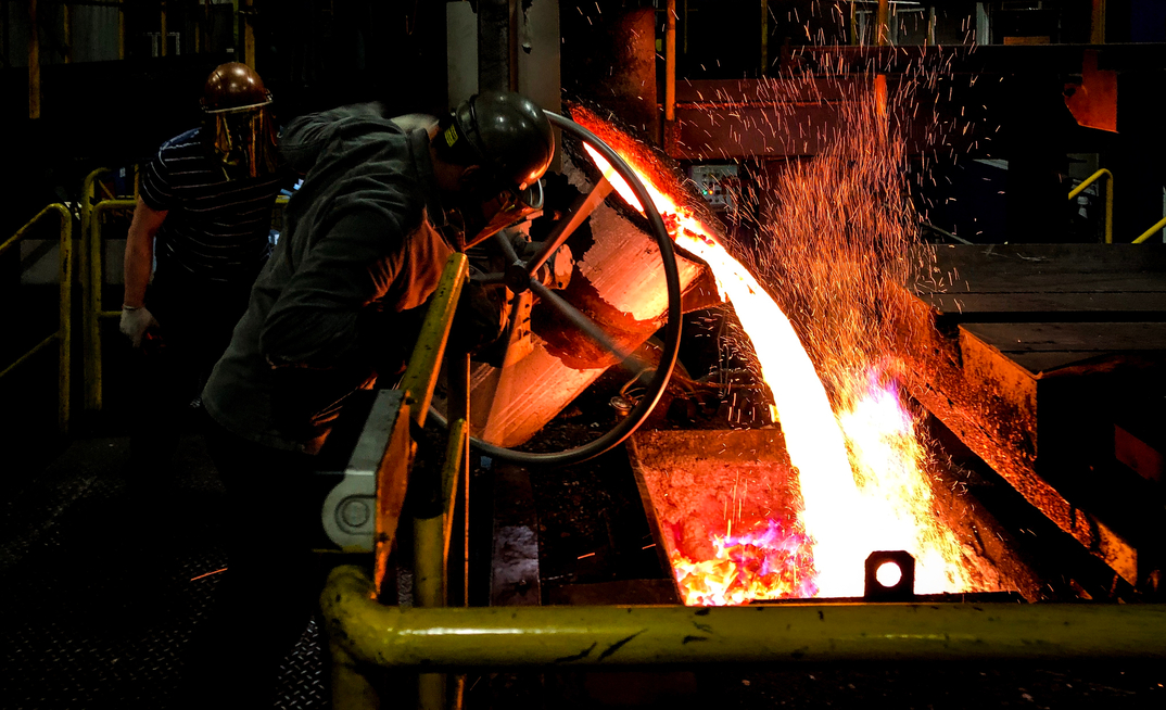Casting molten copper into a furnace.