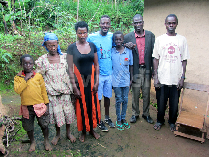 hisa in blue tshirt and slippers being resettled with family in ududa