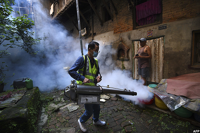   worker operates a fogging machine to kill mosquito larvae to fight the spread of dengue fever and other mosquitoborne diseases in a resident area of athmandu epal