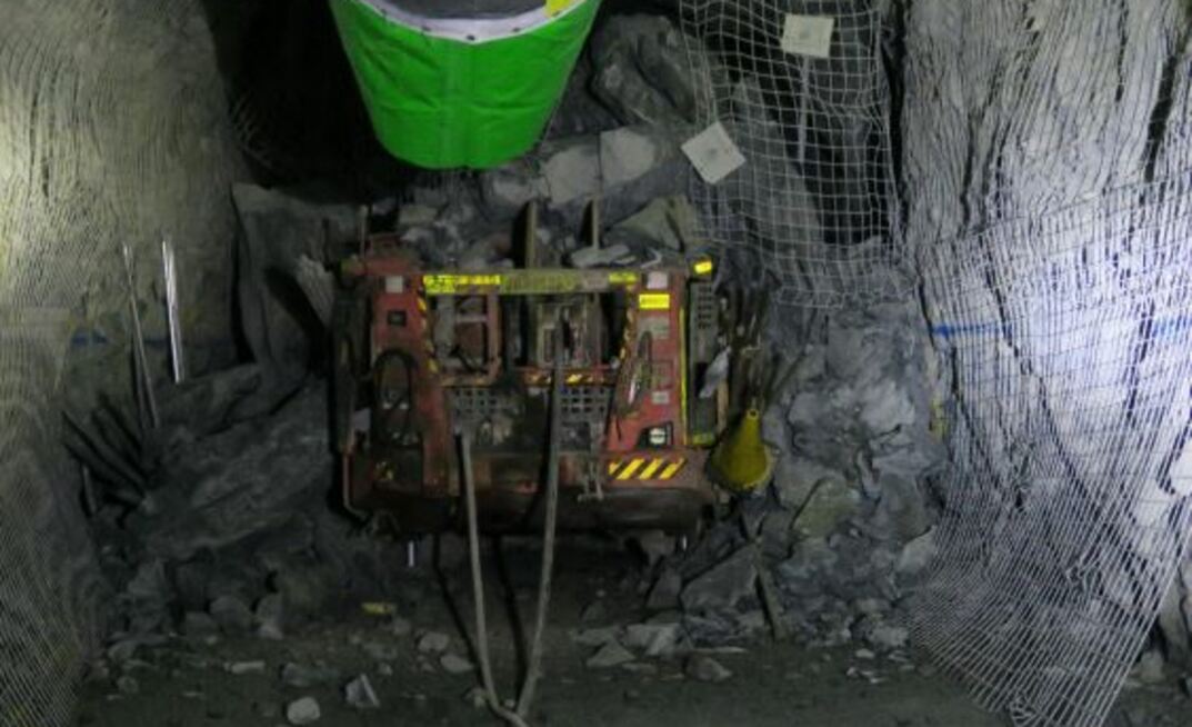 The jumbo drill rig partially buried by the roof collapse
