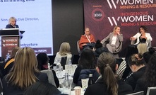 Elliott (in orange) speaking at the summit.