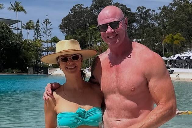 AFL legend Barry Hall and wife Lauren Brant flaunt their fit physiques during day out at the beach