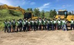 Anglo American and Komatsu teams stand united after a day of planting trees together at a 90ha site at the Dawson mine