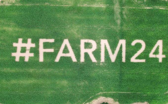 Giant #farm24 logo planted in field of maize 