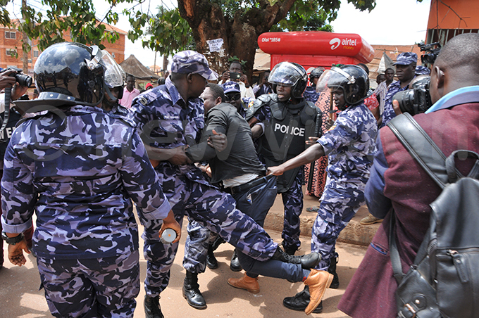 olice tussles with a student who resisted arrest claiming he was not part of the protests hoto by arim sozi