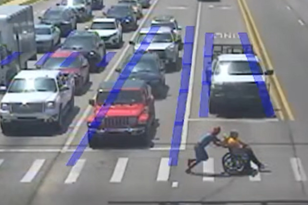 Video- 'Spiderman' leaps into action to help wheelchair user cross street in traffic