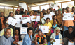  A community in Western Highlands Province showing off their vision boards after successful completing the MoneyMinded which is ANZ’s flagship financial literacy program.