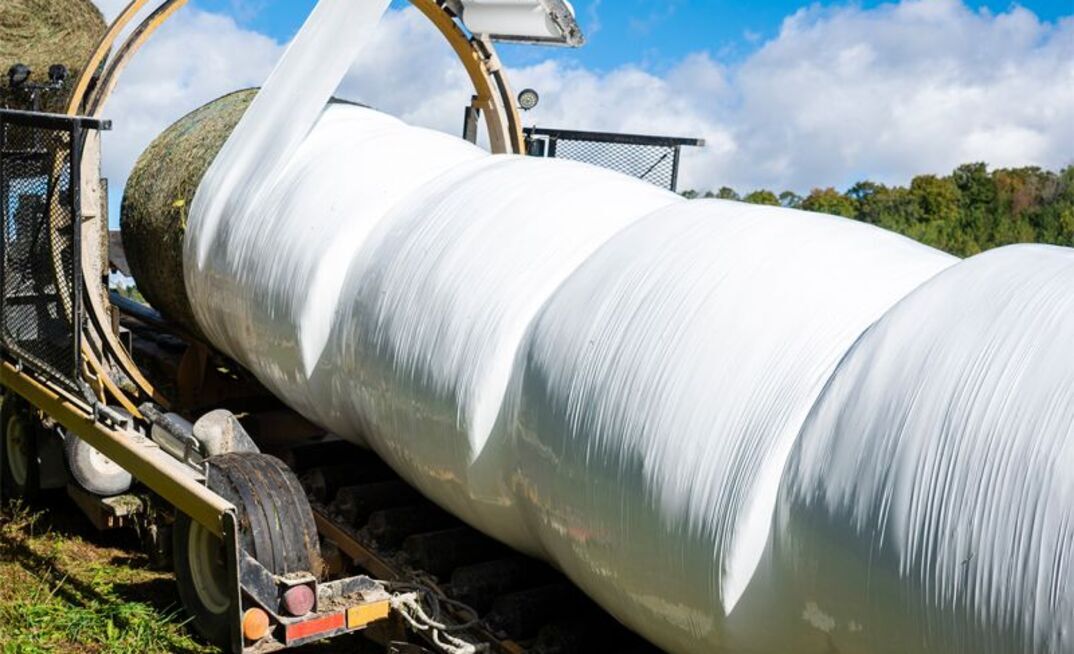 A farm operator has been charged after a worker was killed while operating a bale wrapper.