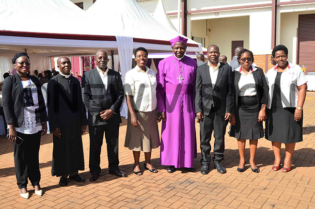  he outgoing rchbishop of hurch of ganda tanley tagali with some members of the xco of oint edical tore during his farewell visit to the organisation in sambya on ednesday ovember 13