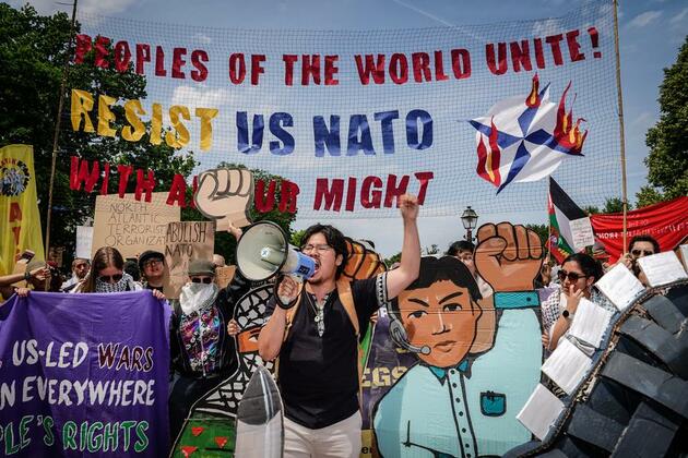 NATO is global driver of conflicts, U.S. activist says at pre-summit protest