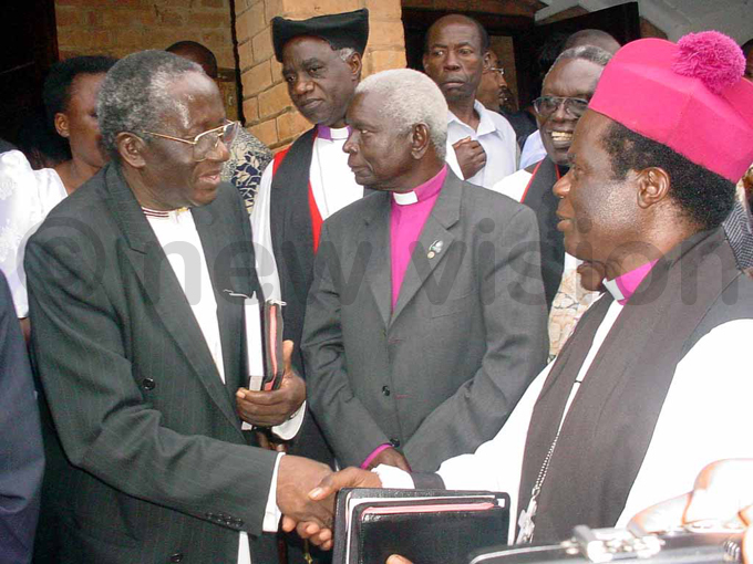 rof ajubi is consoled by retired rchbishop of the hurch of ganda ivingstone koyoyo after a funeral service for his late wife at amirembe athedral in 2006