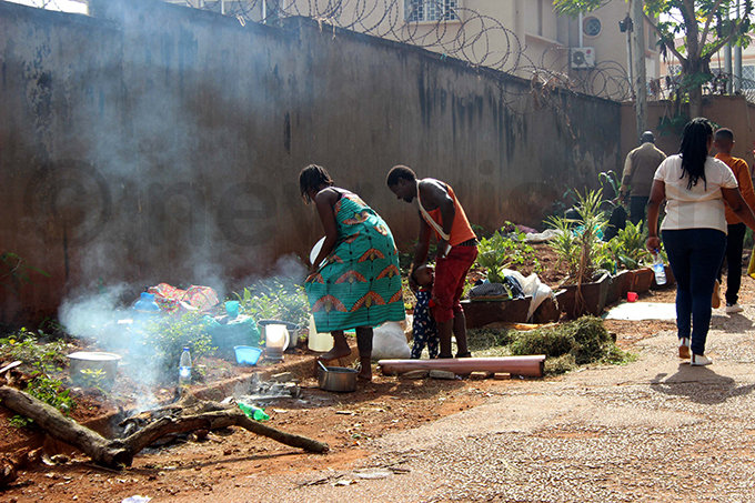 ome refugees preparing meals near the entrance of the  offices hotos by eddie usisi