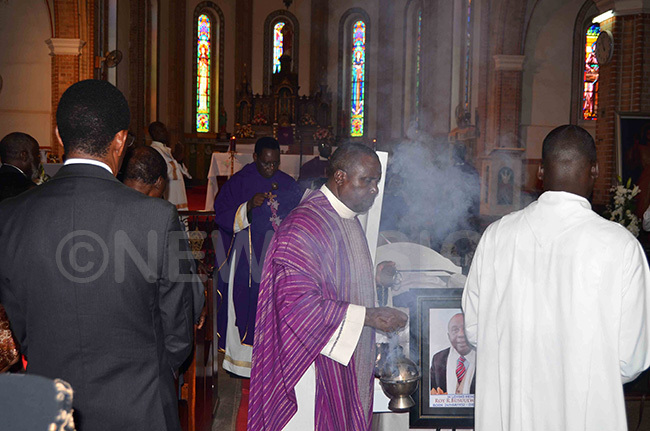 he priest blessing the body of the late sereko 