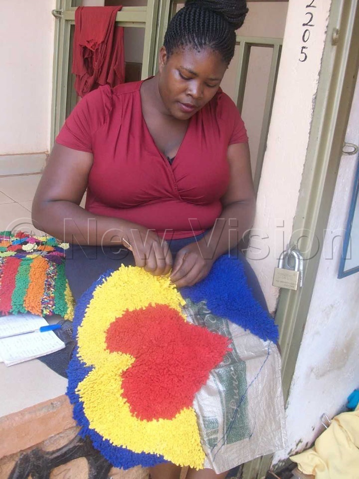 Kiggundu making a door mat
