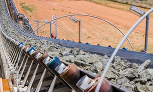 Platinum rock being moved on a conveyor belt.