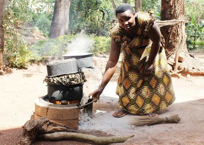 aguhirwa cooking using a akastove he stove emits less smoke and saves on the amount of wood burnt during the cooking hoto by hmad uto