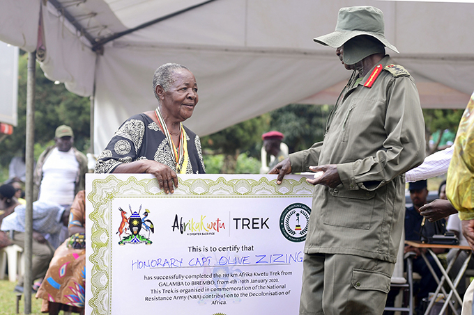 resident useveni hands over a dummy certificate to apt live izinga at the end of the trek  hoto