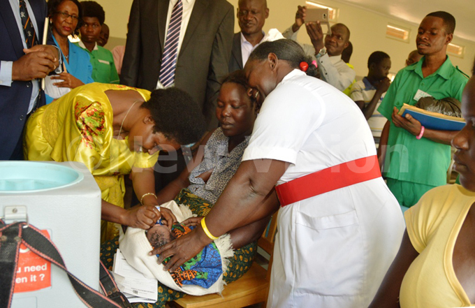  inister kiror immunizing a newly borne baby at the refurbished maternity ward at apelebyong   in muria on wednesday     
