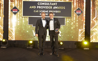 Jimmy McGhie (left) hands the award to Tusker chief executive Paul Gilshan (right)