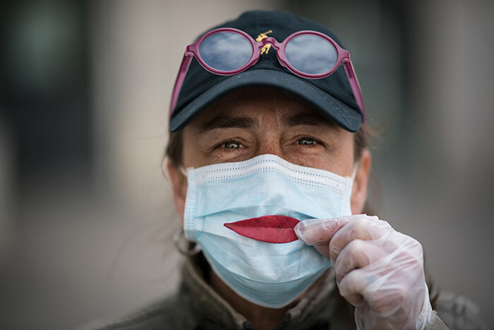 woman wearing a protective mask holds a leaf as a smile in antes western rance on arch 29 2020 on the thirteenth day of a lockdown aimed at curbing the spread of 19 novel coronavirus in rance hoto by oic