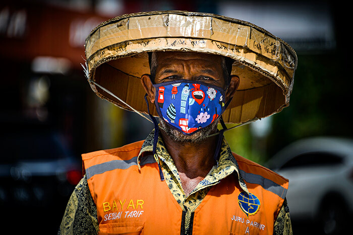 man wearing a face mask amid concerns of the 19 coronavirus walks on a street in anda ceh on arch 28 2020 hoto by