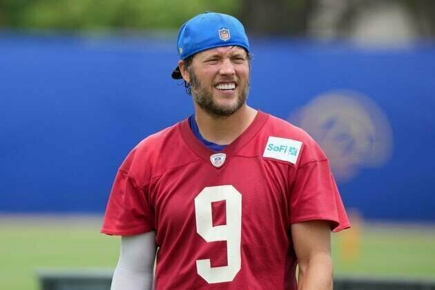 Rams QB Matthew Stafford (back) participates in first practice