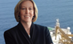 Woodside CEO Meg O’Neill pictured in front. Behind, a drillship supporting Senegal’s historic Sangomar oil project, the nation’s first offshore development to reach production.