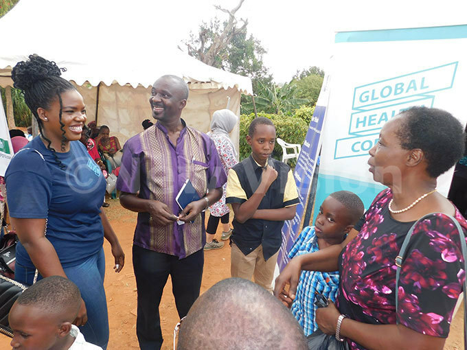  he enior edical fficer in harge on onommunicable iseases r erald utungi shares a light moment with members of the local health orps and a resident of utundwe during the health camp organised on orld ealth ay  recently