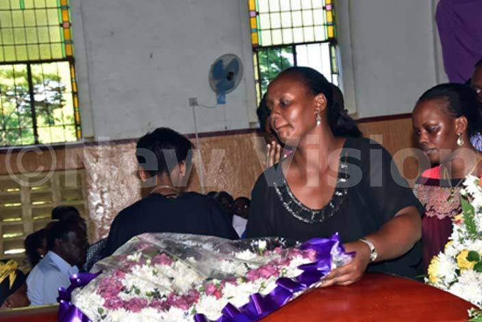  assamis daughter lays a wreath on her fathers casket during the requiem mass hoto by uliet ukwago