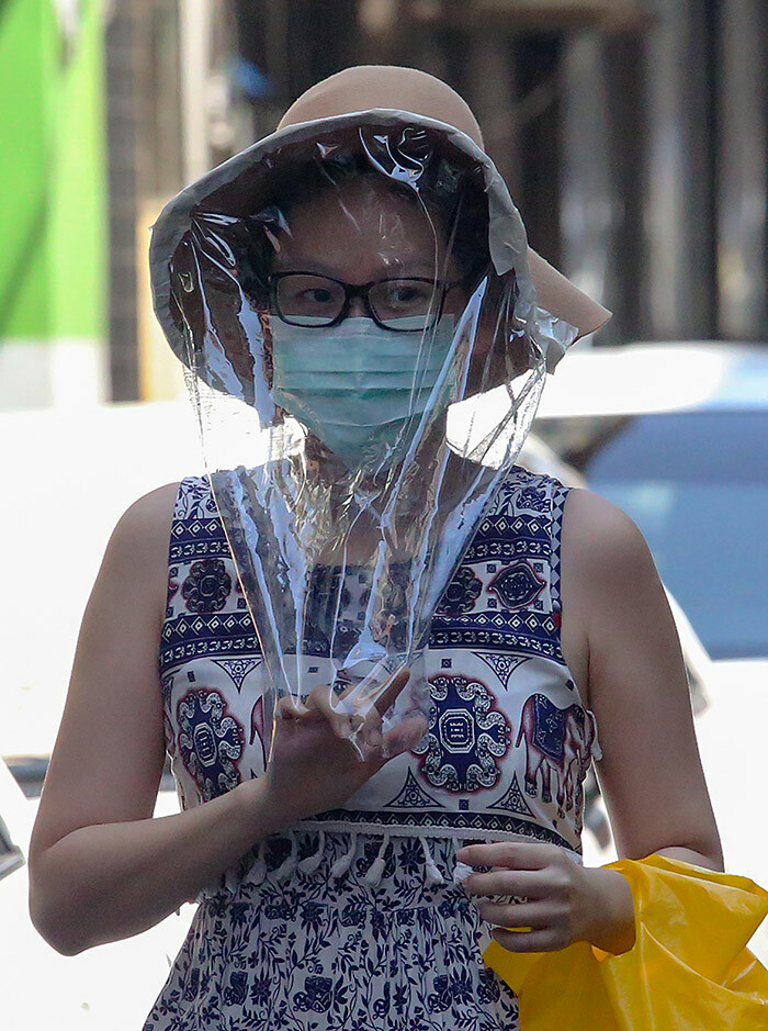 woman wears a facemask and plastic cover over her head amid concerns over the spread of the 19 coronavirus in angon on arch 26 2020 hoto by ai ung ain