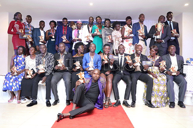  he different awardees pose with their trophies