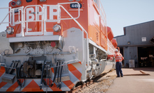  A BHP worker inspects a diesel-powered locomotive at Port Hedland. BHP will replace diesel with battery-electric locomotives over time. Photo: Alucinor Productions, 2021