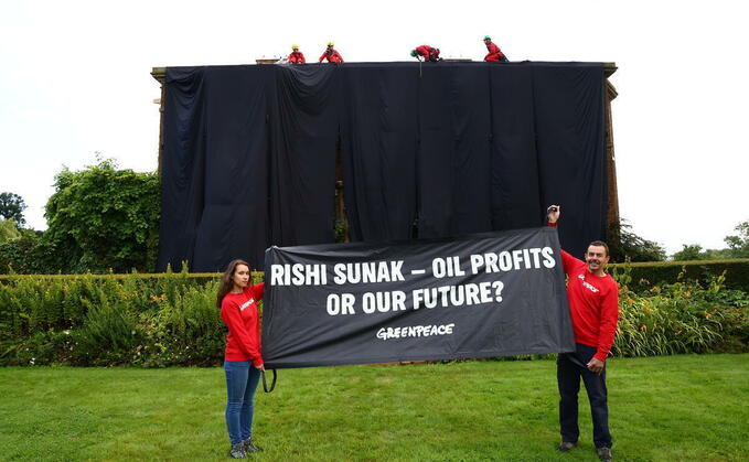 'We need a climate leader, not a climate arsonist': Greenpeace drape Rishi Sunak's manor house in 'oil-black' fabric