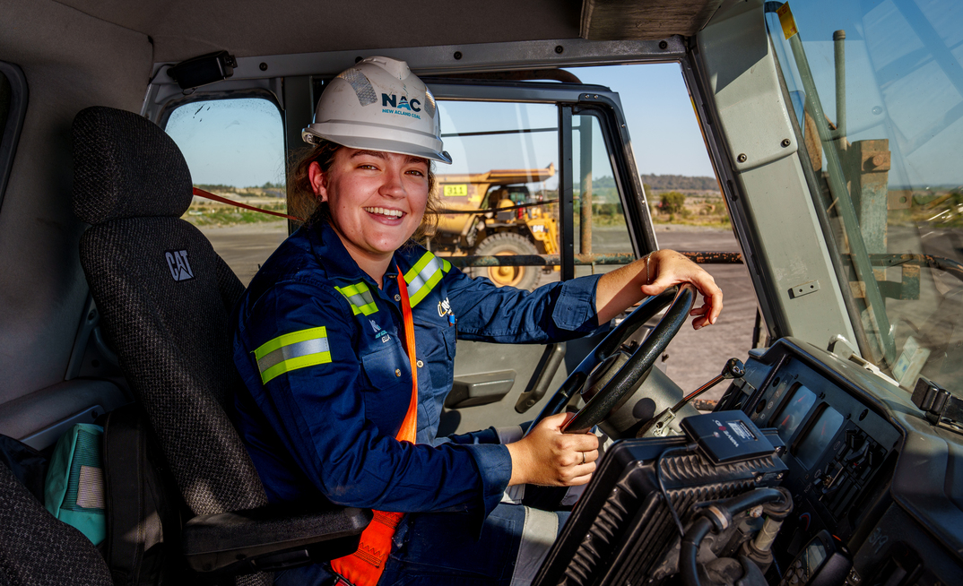 Ella Graham behind the wheel of a Cat haul truck at New Acland. Credit: New Hope Group