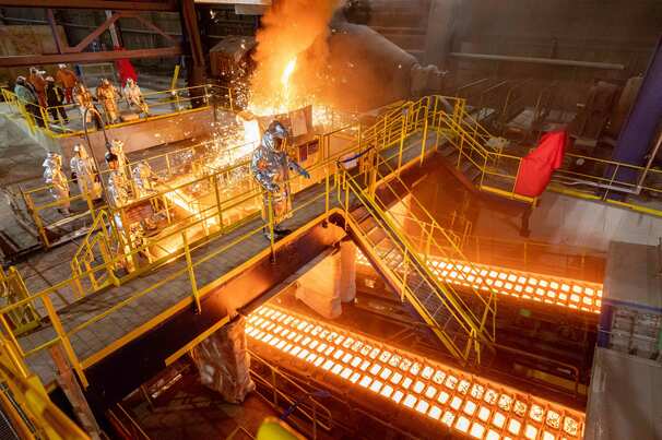 Employees working at the US Steel Gary Works pig iron caster.