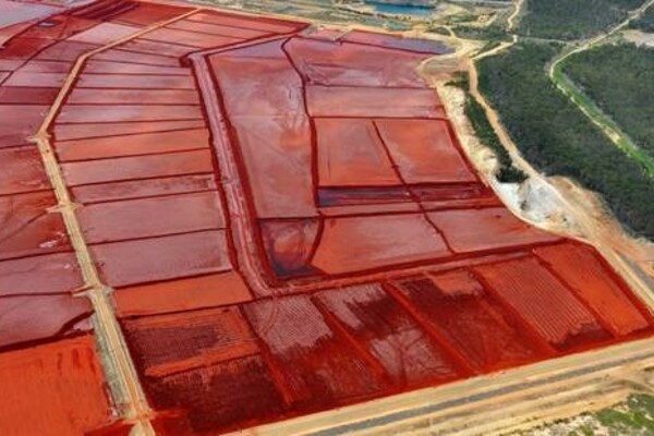 A concrete proposal rises from the red mud