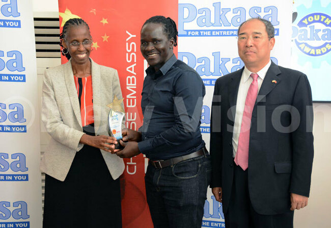  ew ision oard of overnors haiperson onica hibita and the hinese ambassador to ganda  heng hu iang hand over an award to one of the recipients at the akasa oung nterprenuer awards 2018 hoto by iriam amutebi