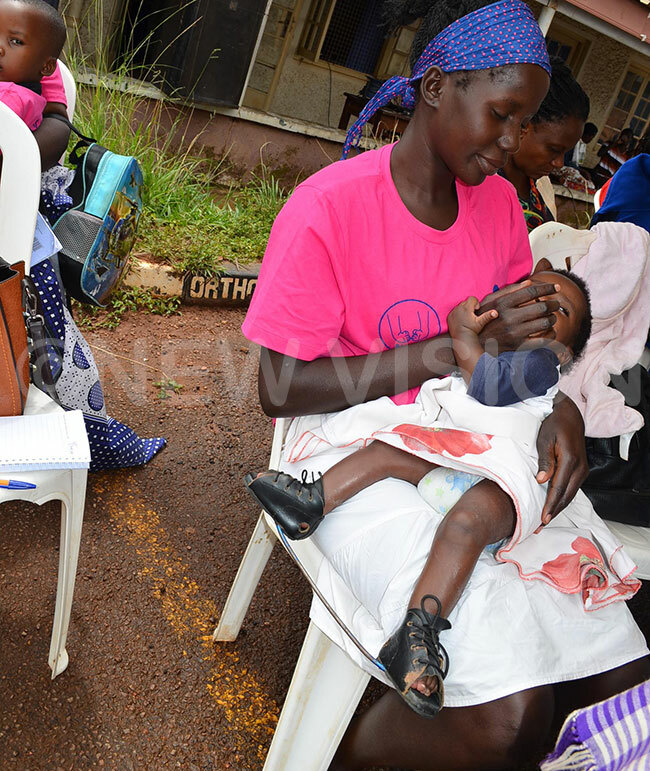  aith amuleme carrying her baby who was born with clubfoot
