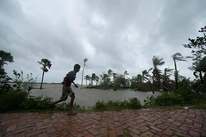   boy runs along an embankment ahead of the expected landfall of cyclone mphan in acope on ay 20 2020 