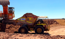 An excavator and truck at Mt Holland.